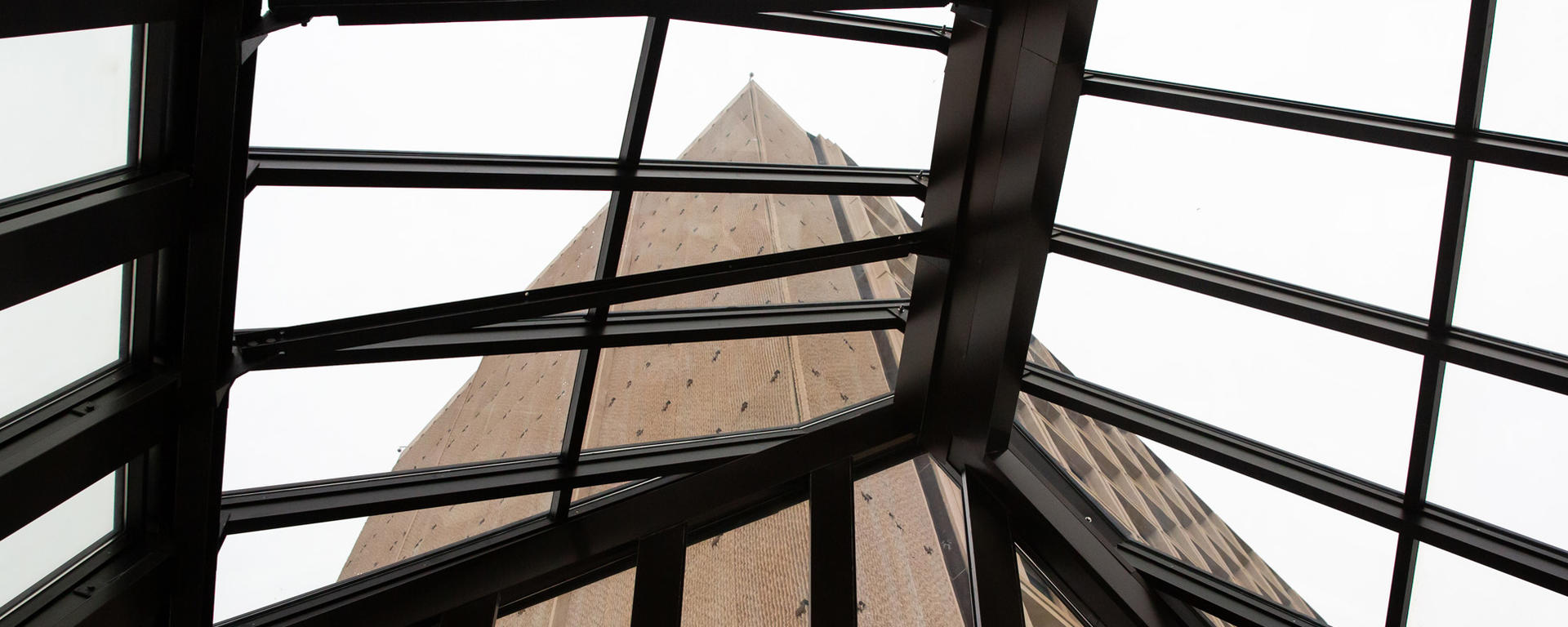 tall brutalist building viewed from a skylight