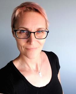 Headshot of female with glasses and short hair