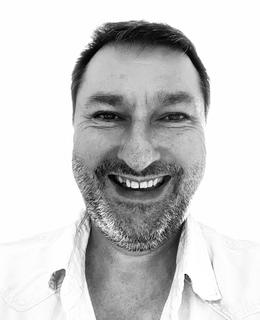 Black and white headshot of Jean-René Leblanc smiling.