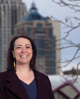 Dr. Jennifer Markides beside Reconciliation Bridge