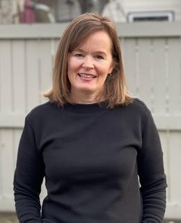 A headshot of Kristine outside.