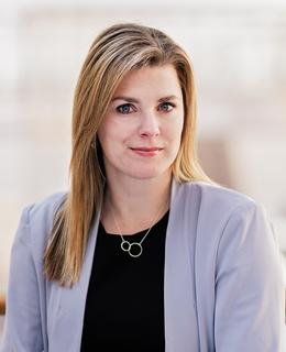 Woman in grey suit jacket