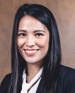 A dark-haired smiling woman