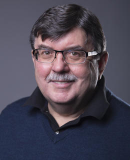 Middle-aged/ older male with dark haor and glasses