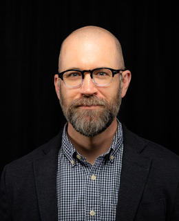 mid-40s male with beard and glasses