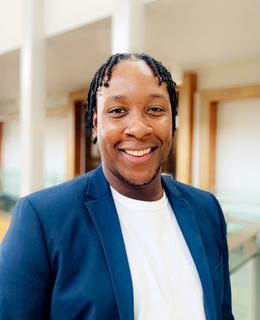 professional headshot in navy blazer