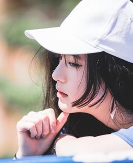 side profile shot of Jessica Tong wearing a white hate