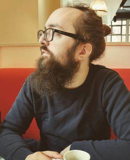 Nicholas Kerklaan sitting in a cafe looking to his right