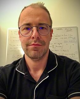 Picture of Dr. Storoshenko in front of whiteboard