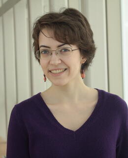 Picture of Kathryn - a person with short, wavy brown hair and glasses