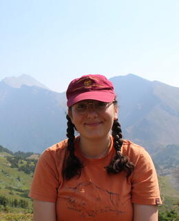 Lusine Petrosyan sitting in front of mountainous landcape