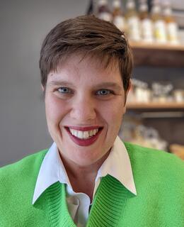 woman with short brown hair in green sweater