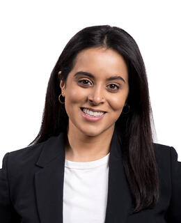 picture of a woman standing in a black blazer