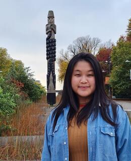 Image of Elias in front of sculpture on UBC campus