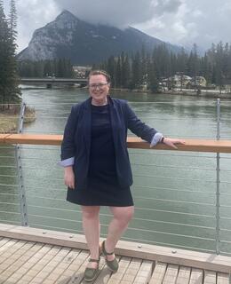 Hayley standing on a bridge with Mount Rundle behind her