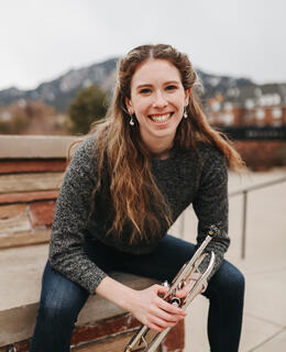 image of woman holding a trumpet