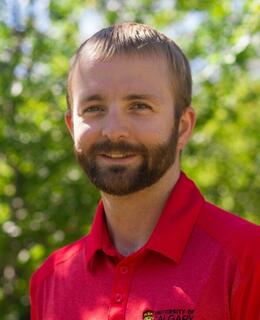 Headshot of Dan Birch a man with short blonde hair and a beard