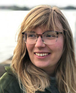 Picture of a white woman with light brown hair and glasses