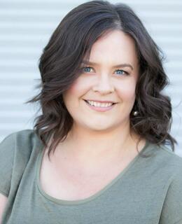 a photo of a woman with shoulder length wavy brown hair