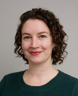 Headshot of Teddi wearing a green sweater