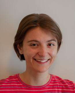 Person with short brown hair smiling at the camera.