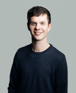 smiling man in a dark blue sweater