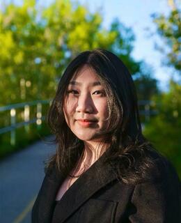 A Asian young woman with black hair and dark eyes