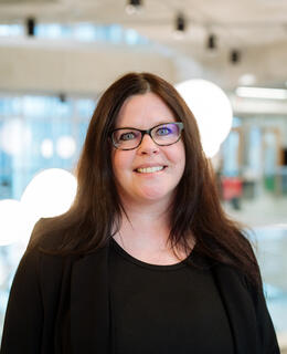 An image of Angela with brown hair and glasses