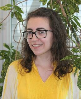 Picture of Kathryn - a person with shoulder length curly brown hair and glasses