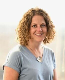 Image of Kelli standing in front of a window