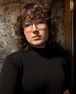 Allison's face. She has short brown hair and glasses.