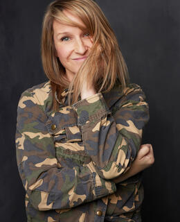 a white woman in a camo jacket