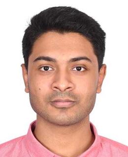 A standard passport sized photo, wearing pink shirt