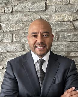 Mark headshot wearing suit and tie
