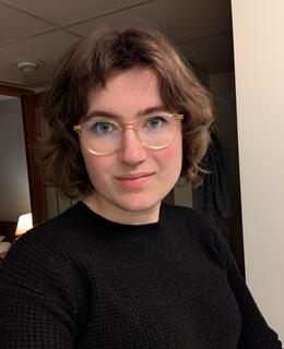 Allison's face. She has short brown hair and glasses.