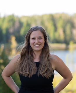 Girl standing in front of trees